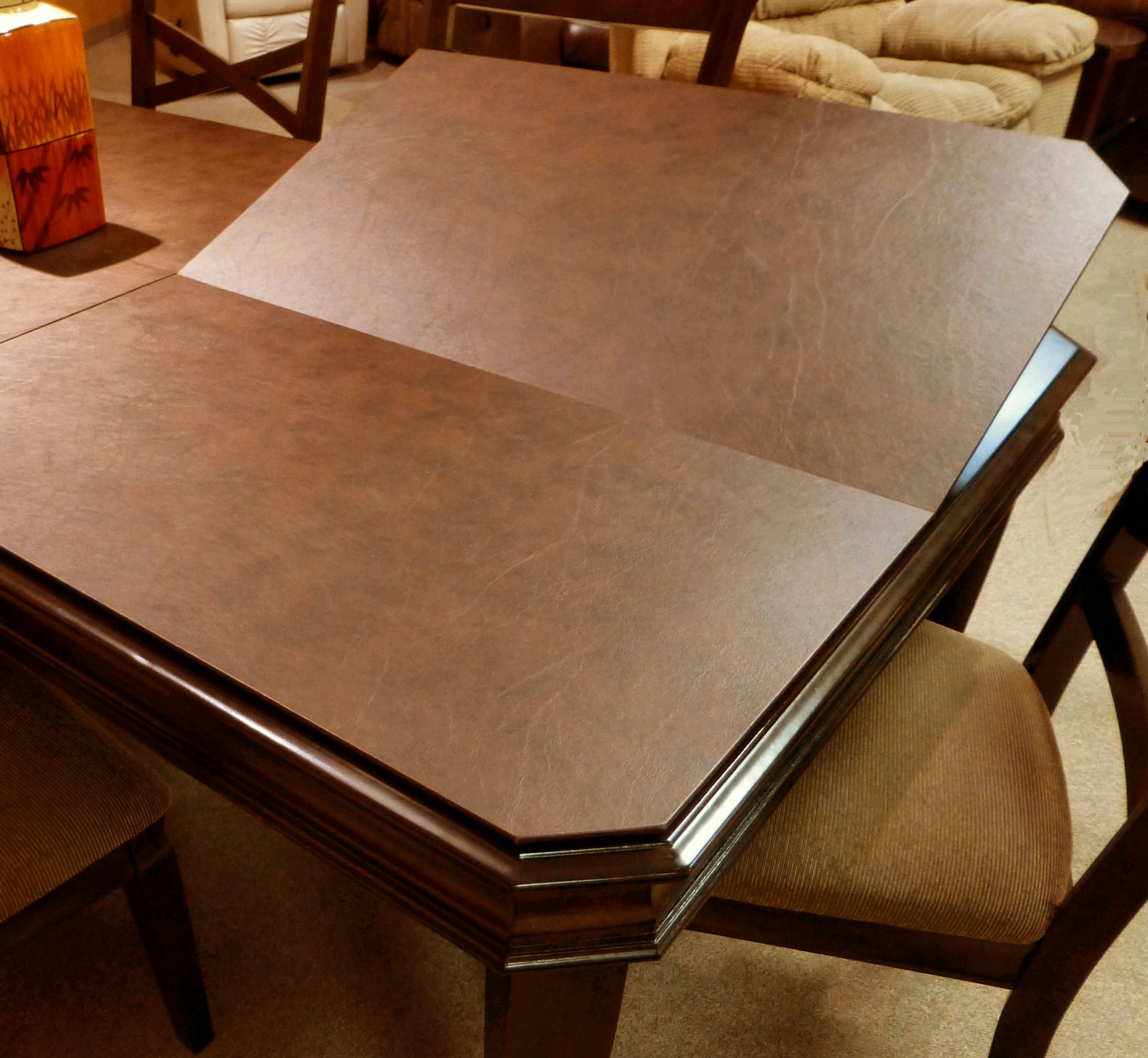 A dining room table protected by a custom Suburban table pad.